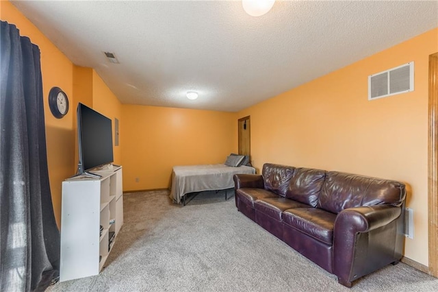 bedroom featuring carpet flooring and a textured ceiling