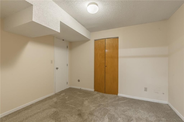 carpeted spare room featuring a textured ceiling