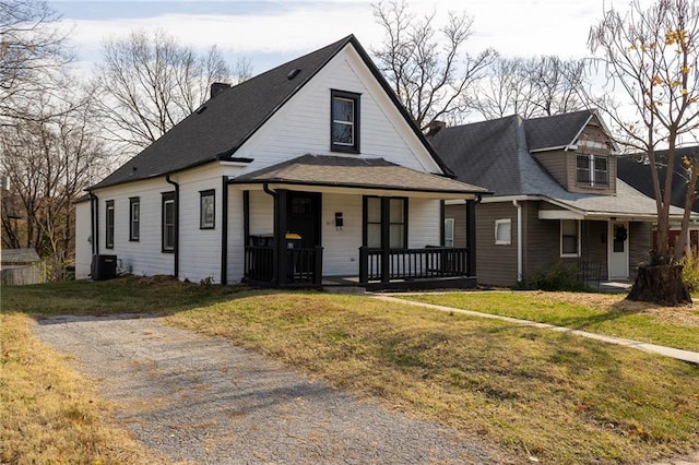 view of front of property featuring central air condition unit, a front lawn, and a porch