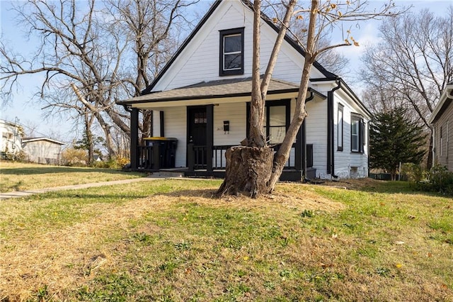 view of front of home featuring covered porch and a front lawn