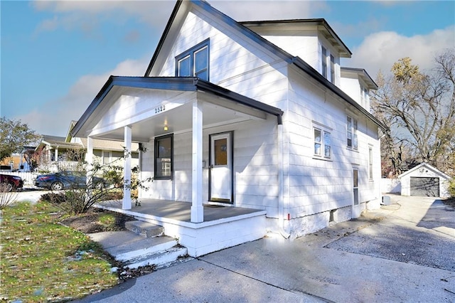 view of front of home featuring covered porch and an outbuilding