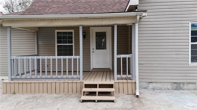 311 W Larch St, Cherokee, KS 66724 - view of exterior entry featuring a shingled roof and covered porch
