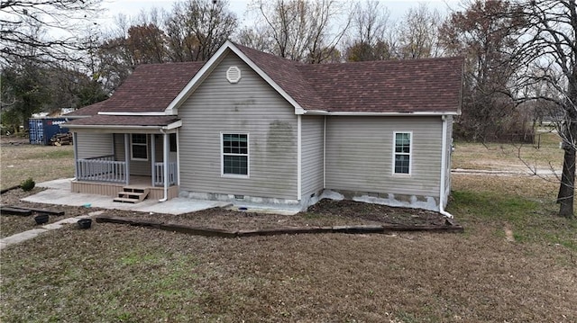 rear view of house featuring a porch