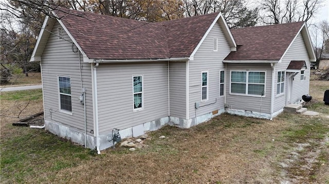 view of side of home featuring a yard