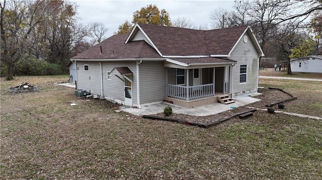311 W Larch St, Cherokee, KS 66724 - view of front of home with a porch, a shingled roof, a front yard, and central AC