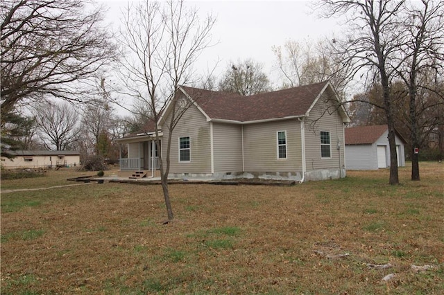 311 W Larch St, Cherokee, KS 66724 - view of side of property with a yard, a porch, crawl space, a garage, and roof with shingles