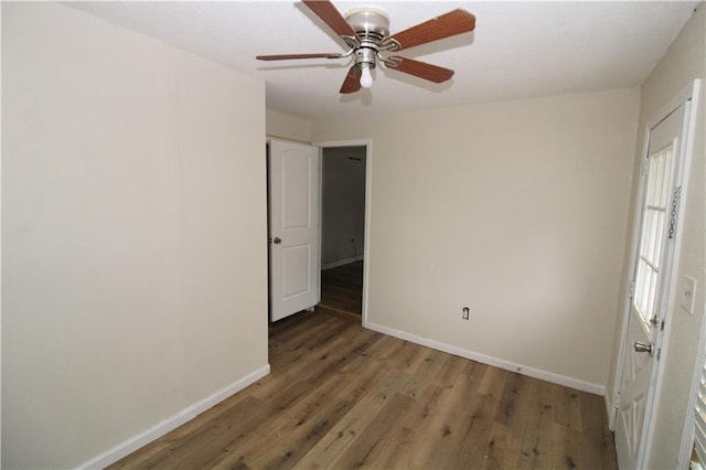 unfurnished bedroom featuring dark hardwood / wood-style floors and ceiling fan