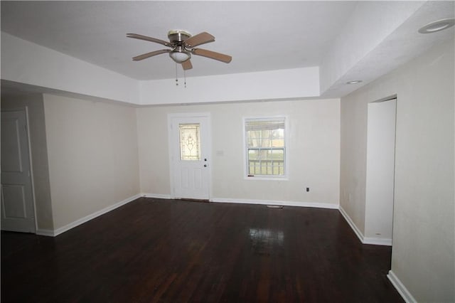 spare room with ceiling fan and dark wood-type flooring