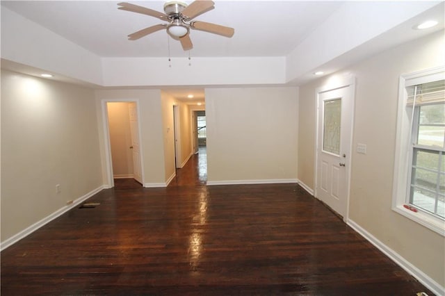 unfurnished room with dark hardwood / wood-style flooring and ceiling fan