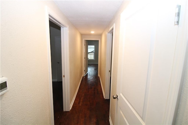 corridor featuring dark wood-type flooring