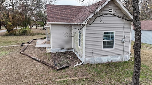 view of side of home with a lawn