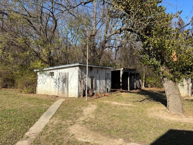 view of outbuilding featuring a yard