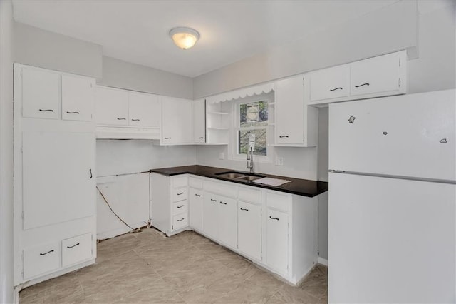 kitchen featuring white cabinetry, sink, white fridge, and exhaust hood