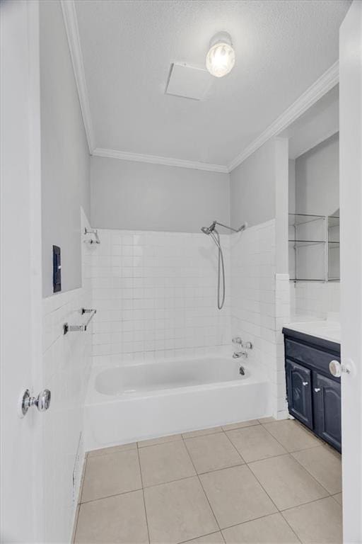 bathroom with tile patterned floors, crown molding, vanity, and tiled shower / bath