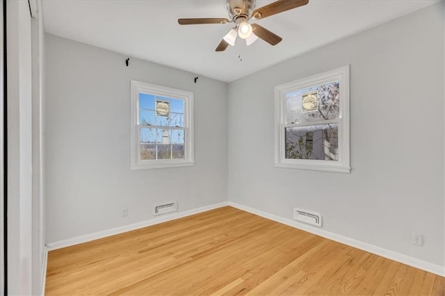 empty room with hardwood / wood-style flooring and ceiling fan