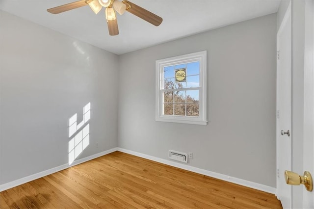 unfurnished room with ceiling fan and hardwood / wood-style floors