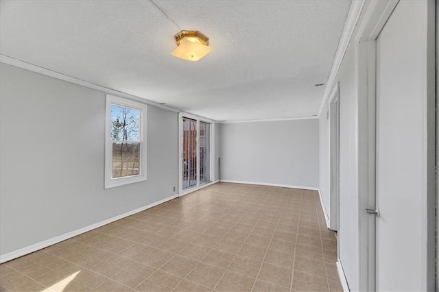 spare room with crown molding and a textured ceiling