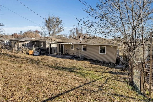 back of house with a lawn