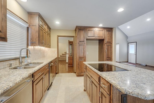 kitchen with light stone counters, stainless steel dishwasher, black electric cooktop, sink, and lofted ceiling