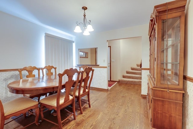 dining space featuring a chandelier and light hardwood / wood-style flooring