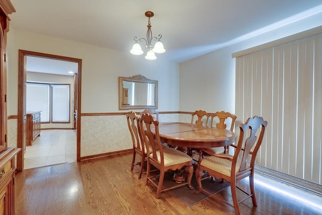 dining area featuring light hardwood / wood-style floors and an inviting chandelier