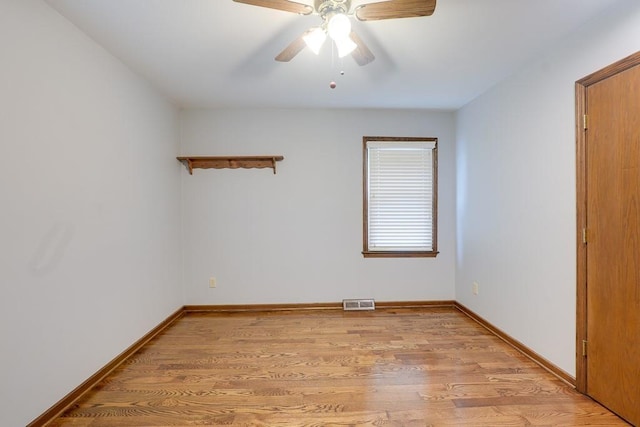 empty room featuring ceiling fan and light wood-type flooring