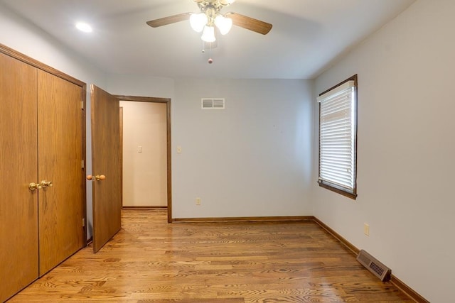 empty room featuring ceiling fan and light hardwood / wood-style floors