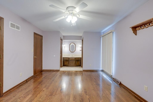 interior space with light hardwood / wood-style floors and ceiling fan