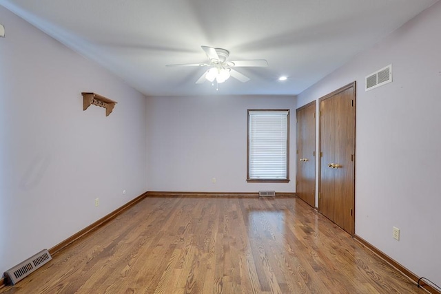 unfurnished bedroom with light hardwood / wood-style floors and ceiling fan