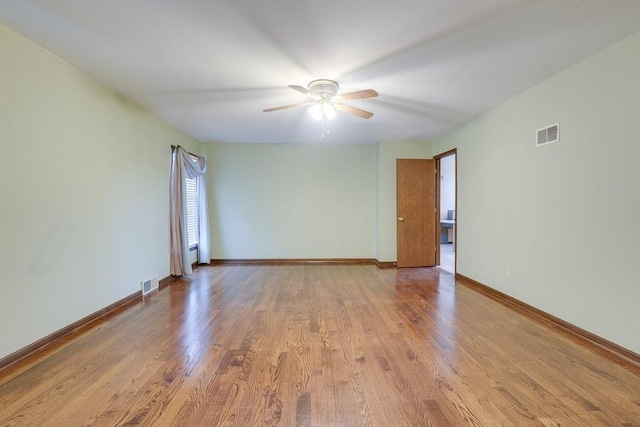 spare room with light wood-type flooring and ceiling fan