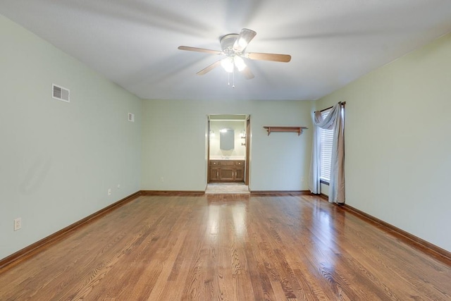 unfurnished room featuring light wood-type flooring and ceiling fan