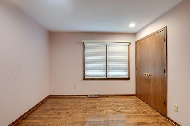 empty room with light hardwood / wood-style flooring