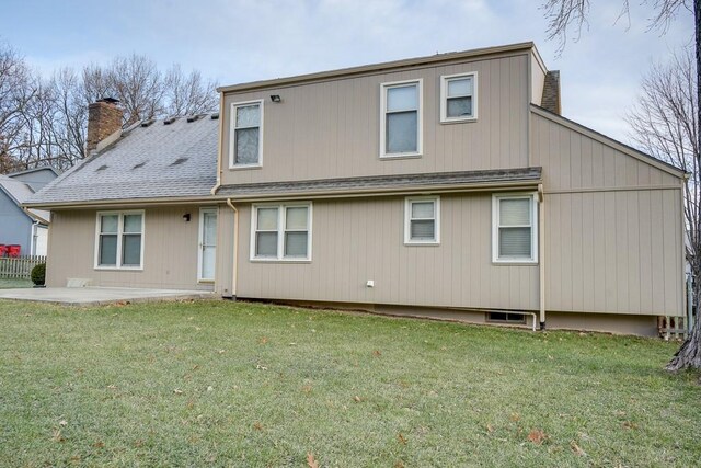 back of property featuring a lawn and a patio area