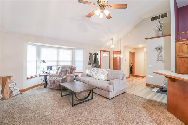 carpeted living room featuring ceiling fan and high vaulted ceiling