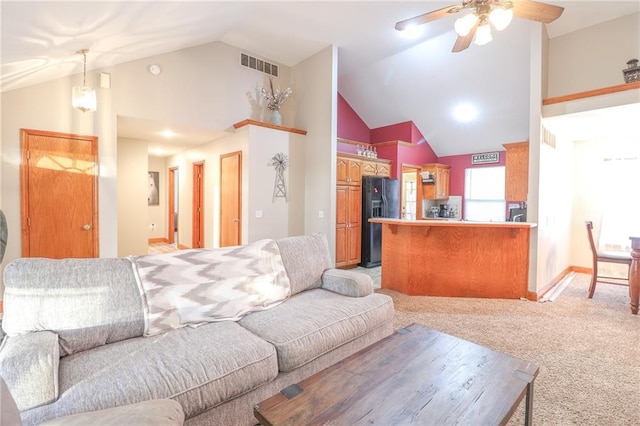 carpeted living room featuring ceiling fan and high vaulted ceiling