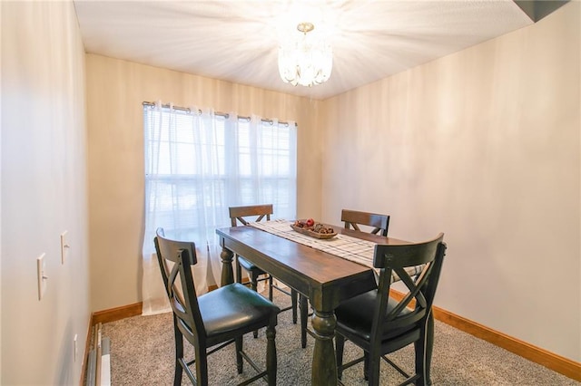 carpeted dining room with a notable chandelier