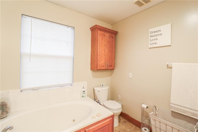 bathroom with a washtub and toilet