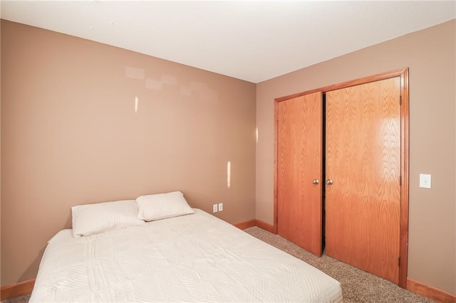 bedroom with light carpet and a closet