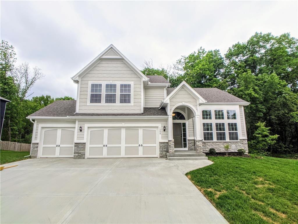 view of front facade with a garage and a front lawn