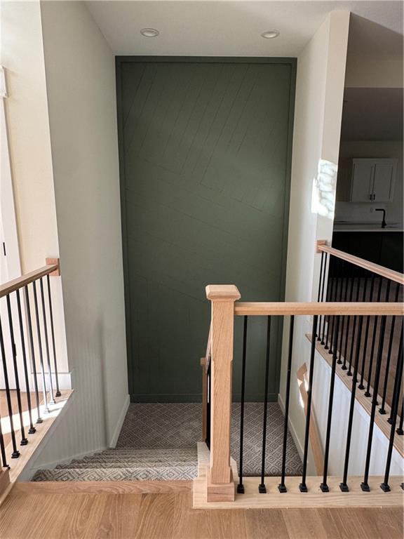 staircase with wood-type flooring