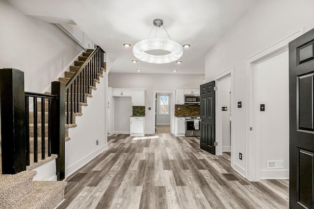 entryway with light hardwood / wood-style flooring