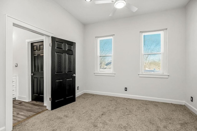 unfurnished bedroom with carpet, ceiling fan, and multiple windows