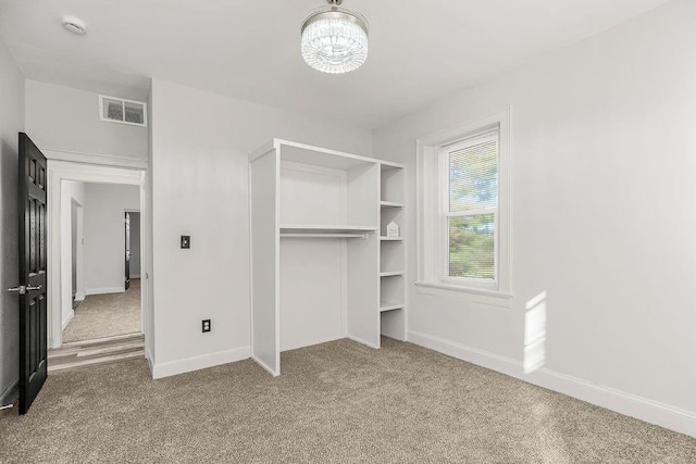 walk in closet with carpet floors