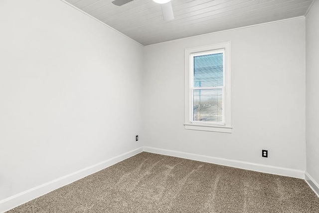 carpeted empty room with ceiling fan, wooden ceiling, and ornamental molding