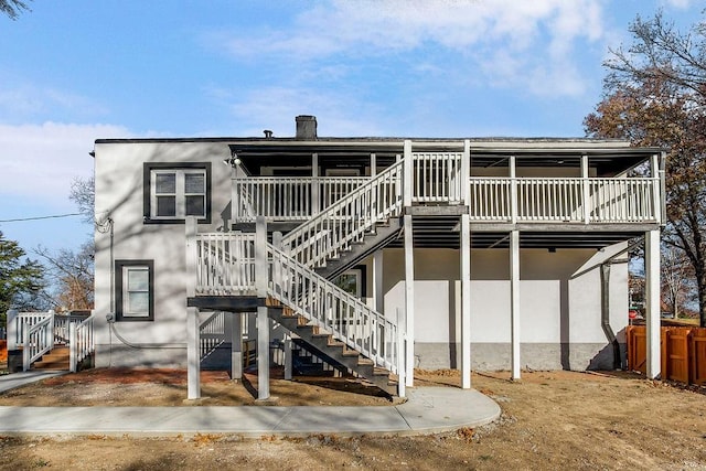 back of property featuring a wooden deck