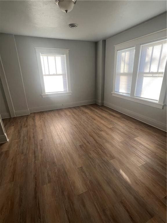 unfurnished room with dark hardwood / wood-style floors