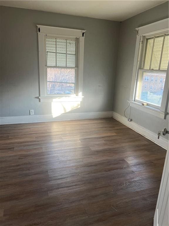 unfurnished room featuring dark hardwood / wood-style floors