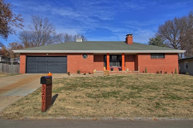 ranch-style home with a garage and a front lawn