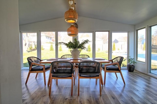 sunroom featuring a healthy amount of sunlight and vaulted ceiling