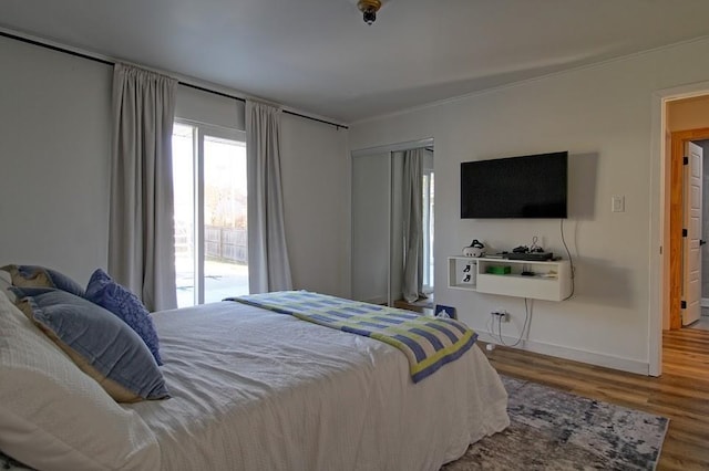 bedroom featuring access to outside and hardwood / wood-style flooring